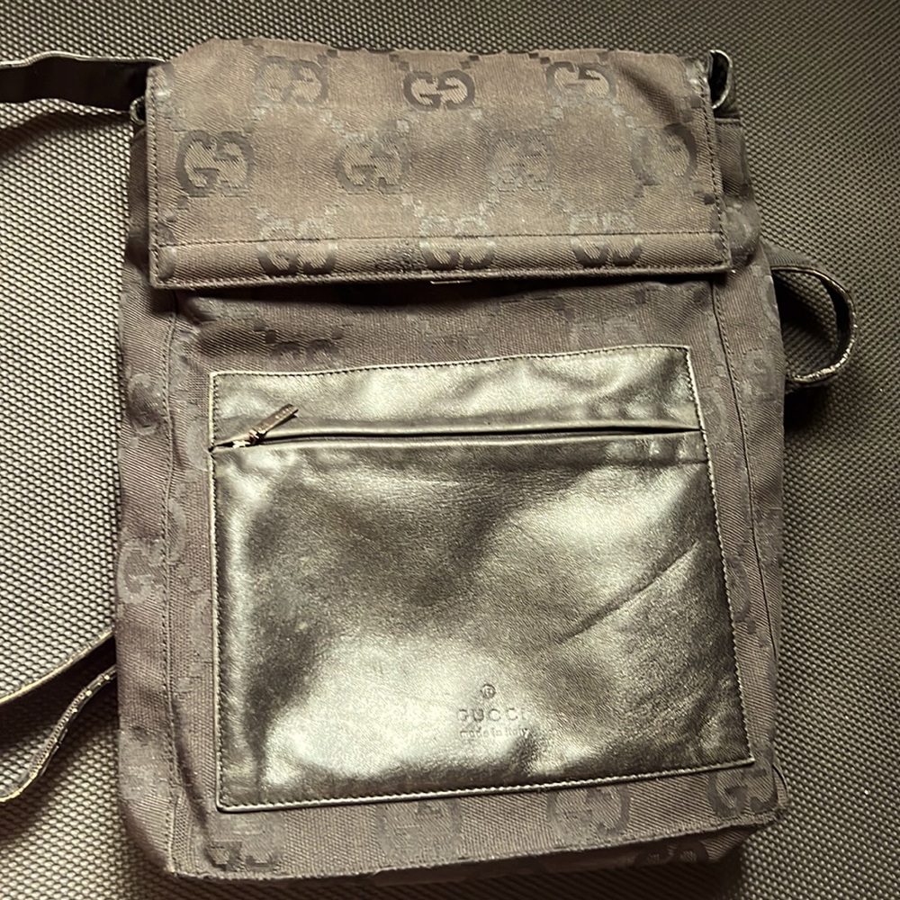 Black Gucci with monogram back pack. Black leather straps. Medium size.